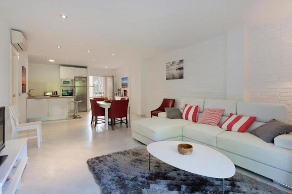 a living room with a couch and a table at Apartment near the Pine Walk in Pollença