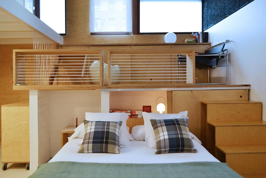 a bedroom with a bed with two pillows on it at ATERIAN LOFT 2 in Zarautz