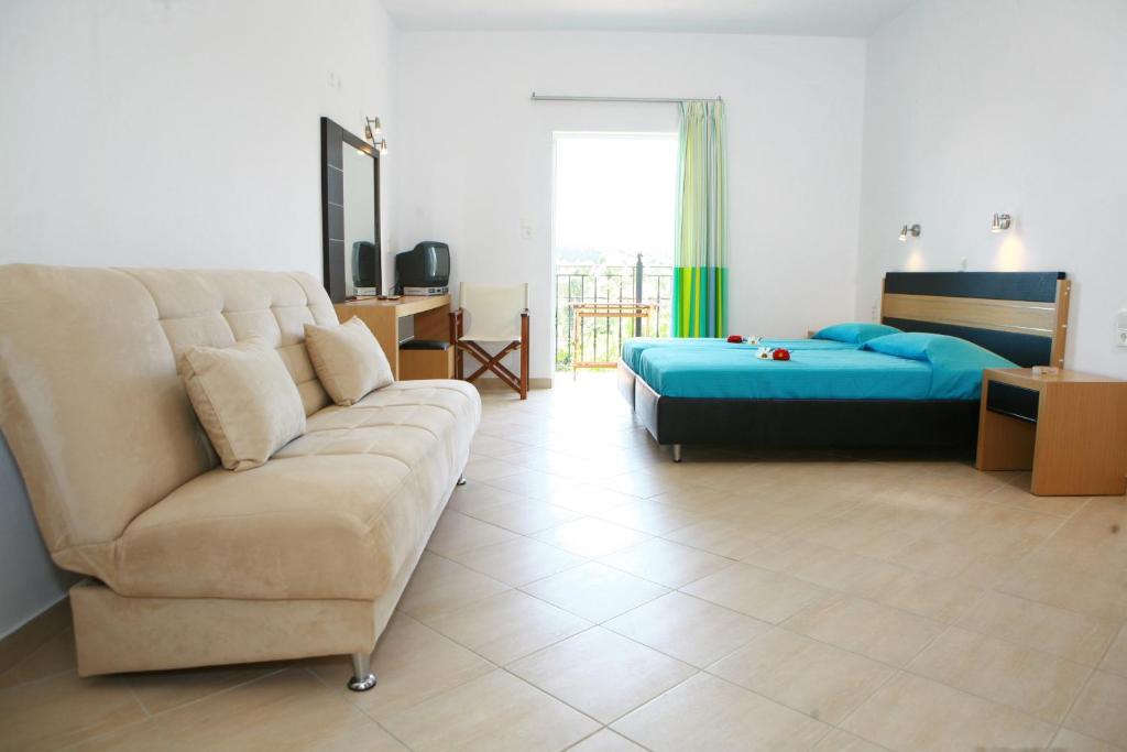 a living room with a couch and a bed at Villa Thomas Valtos beach in Parga