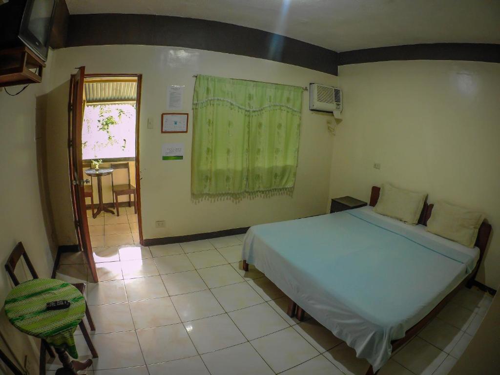 Postel nebo postele na pokoji v ubytování Remari Tourist Inn
