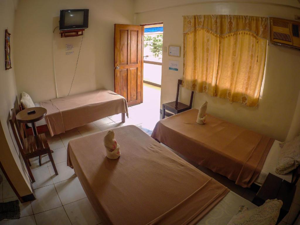 Postel nebo postele na pokoji v ubytování Remari Tourist Inn