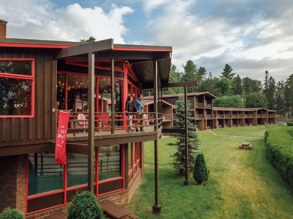 a rendering of a resort building with people on the balcony at Lake House at High Peaks Resort in Lake Placid