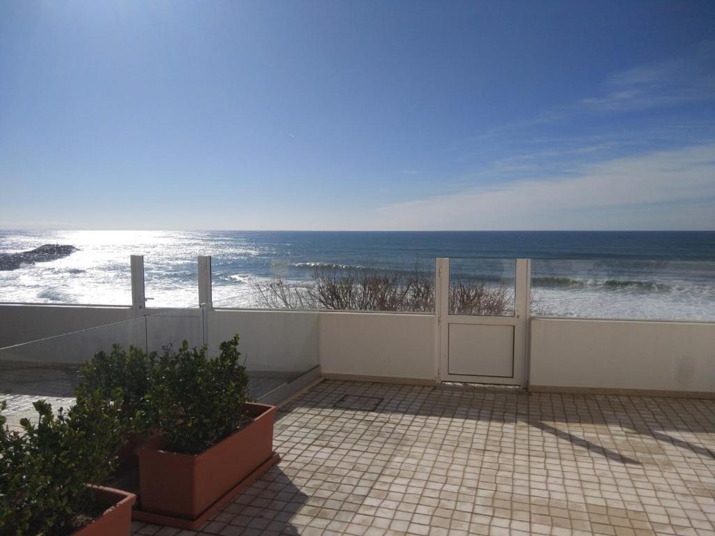 a view of the ocean from the balcony of a house at Ribalta Beach Houses in Ericeira