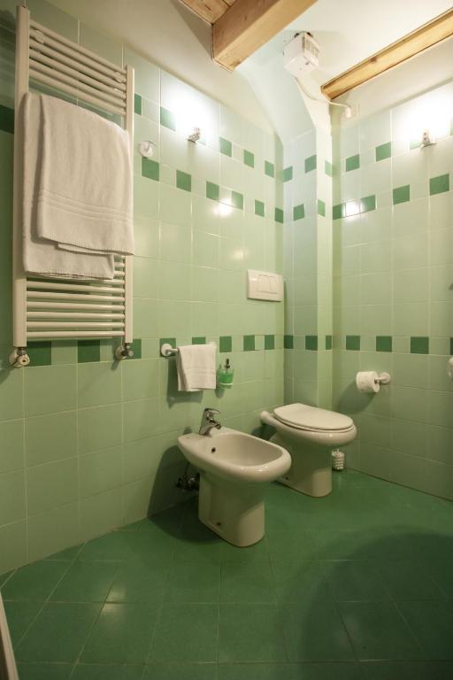 zielona łazienka z toaletą i umywalką w obiekcie Venice Apartment w Wenecji