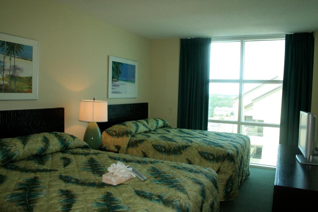a hotel room with two beds and a window at Seaside Resort by Capital Vacations in Myrtle Beach