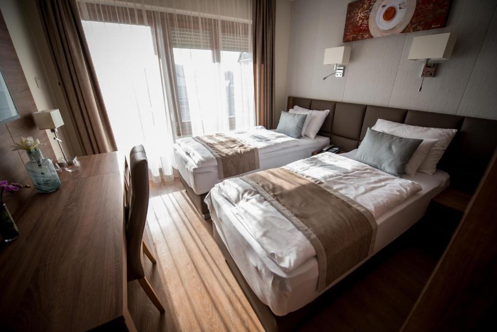 Postel nebo postele na pokoji v ubytování Mokka House Panzió