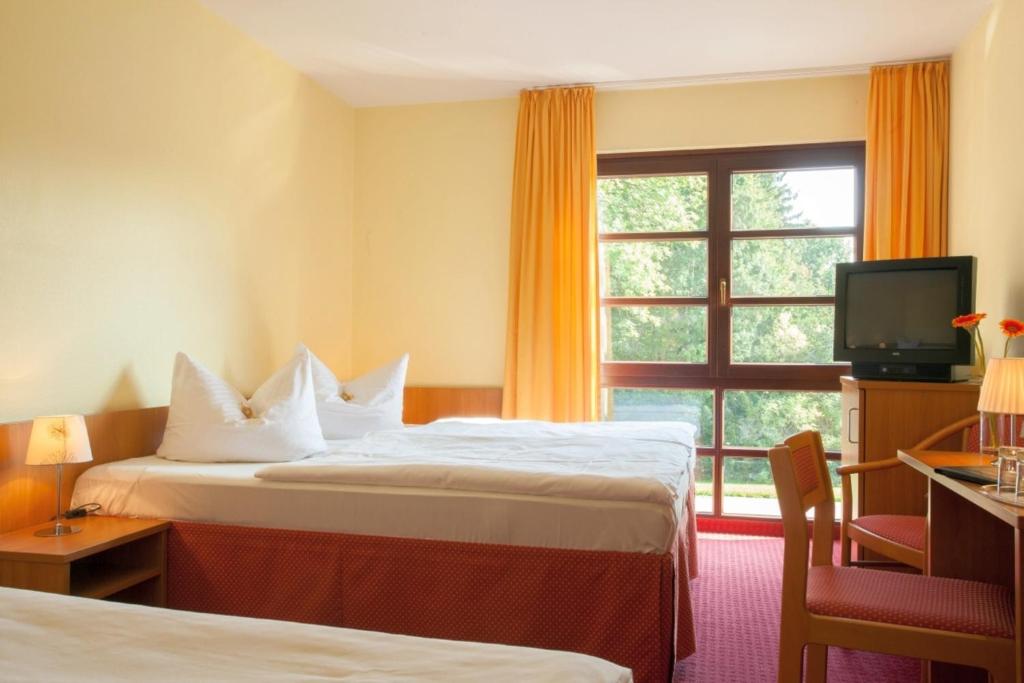 Postel nebo postele na pokoji v ubytování Kim Hotel Im Park