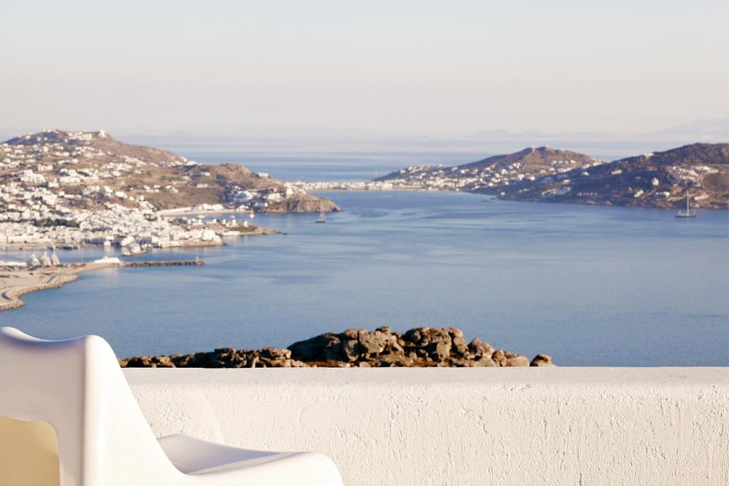 a view of the ocean from a white bench at Amare Mykonos in Tourlos