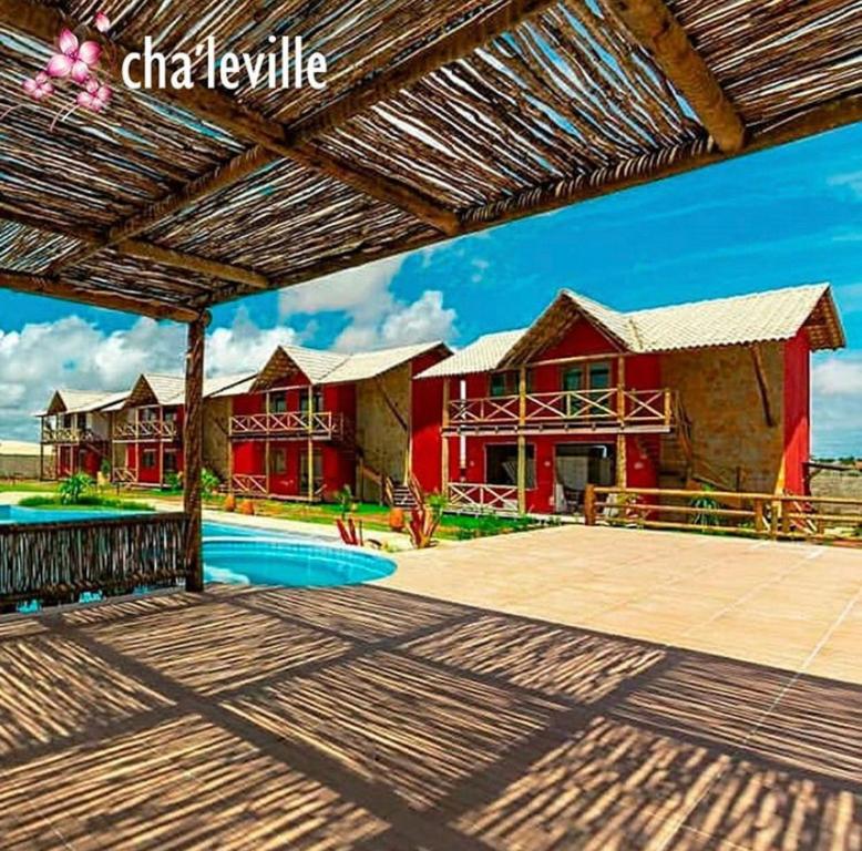 a house with a swimming pool in front of it at Chale´Ville Charme 902 in Luis Correia