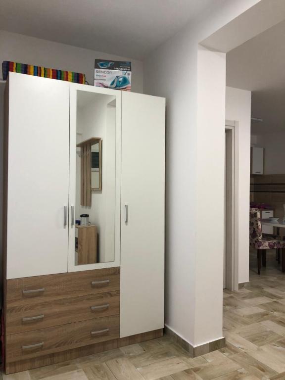 a large white cabinet with a mirror in a room at J&B LUX Apartment in Herceg-Novi