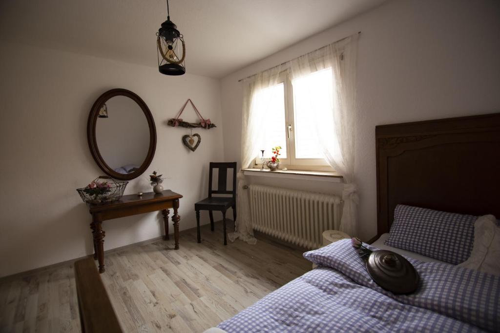 1 dormitorio con cama, espejo y ventana en Fewo Froschkönig, en Schieder-Schwalenberg