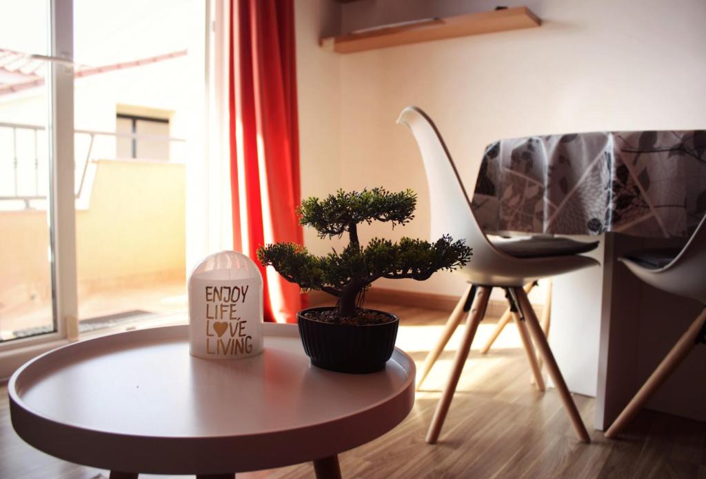- un salon avec une table, une télévision et une plante dans l'établissement Maremy, à Zadar