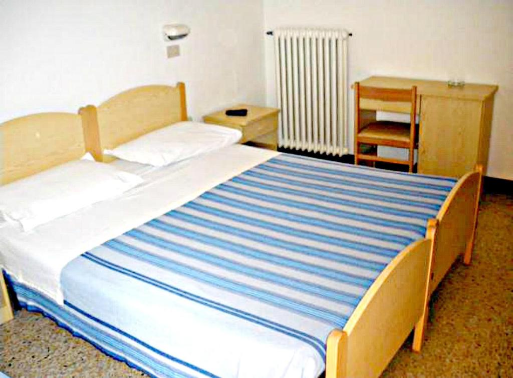 Postel nebo postele na pokoji v ubytování Hotel Ronconi