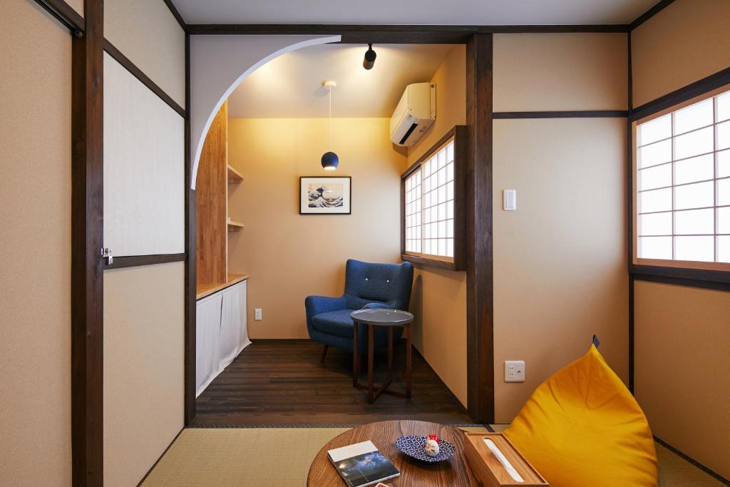 a hallway with a blue chair and a table at Machizukitei in Kyoto