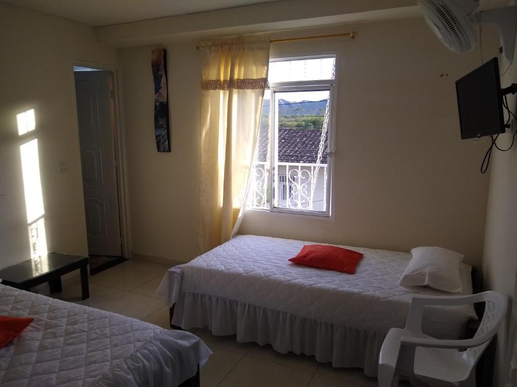 Postel nebo postele na pokoji v ubytování Hotel Maxim