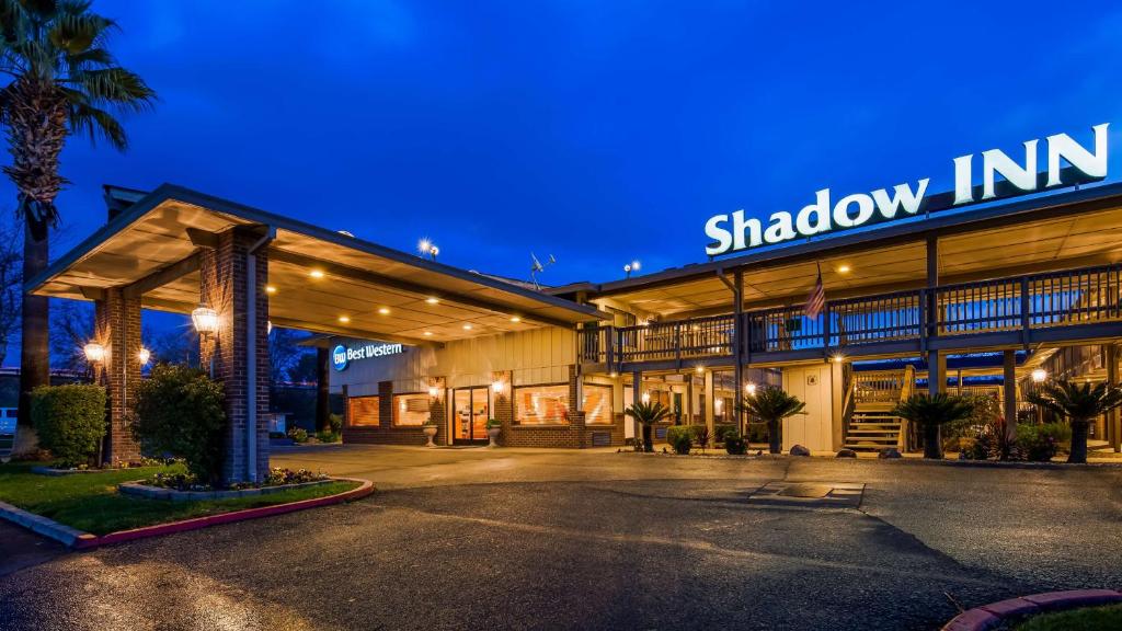 a building with a sign that reads shadow inn at Best Western Shadow Inn in Woodland