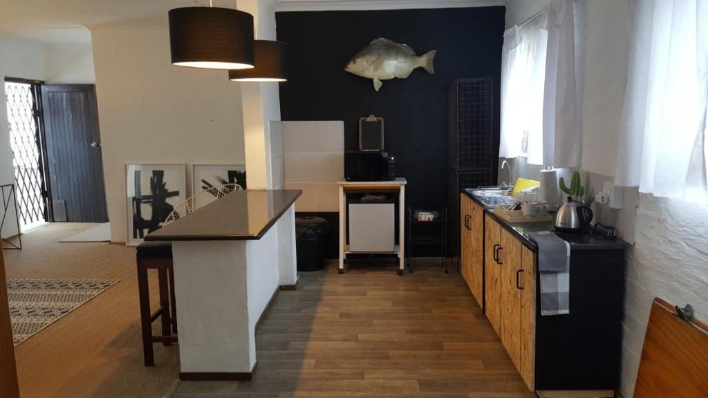 a kitchen with black walls and a counter top at loft 33 in Pietermaritzburg