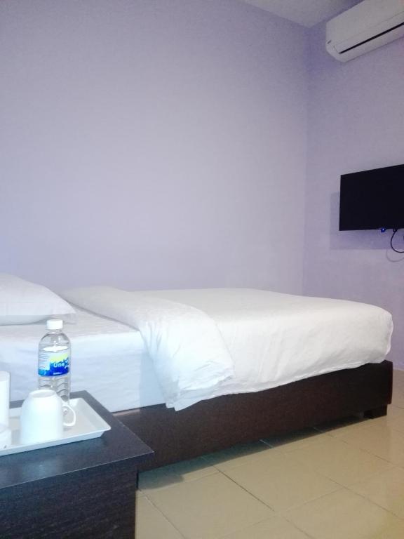 Postel nebo postele na pokoji v ubytování TIONG HUA HOTEL