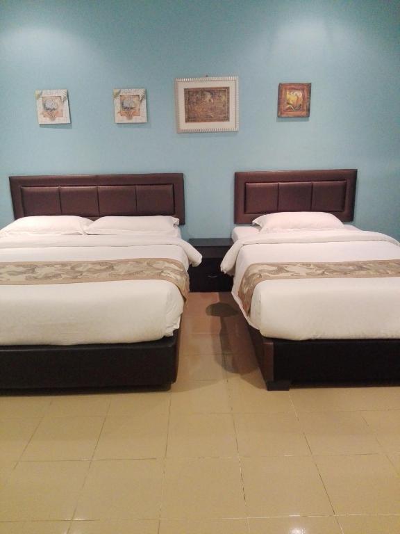 Postel nebo postele na pokoji v ubytování TIONG HUA HOTEL