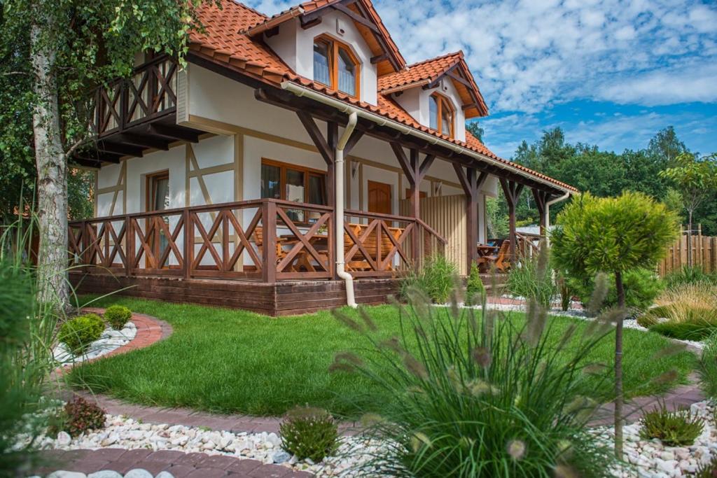 a house with a garden in front of it at Domki Wioska Rybacka in Hel