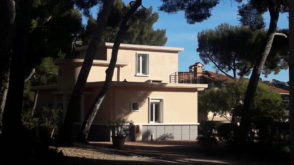 a white house with trees in front of it at LOU CIGALOU in Cassis