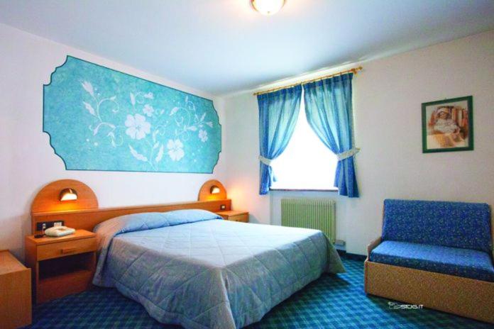 Postel nebo postele na pokoji v ubytování Hotel Ristorante Milano