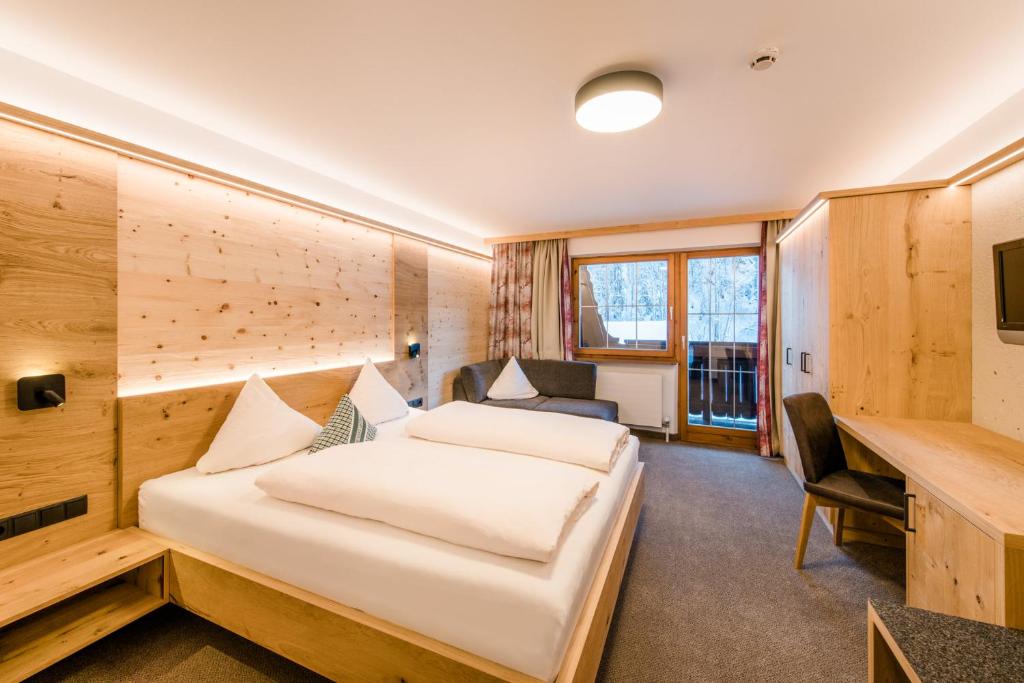 a hotel room with a bed and a desk at Pension Waidmannsruh in Oberau