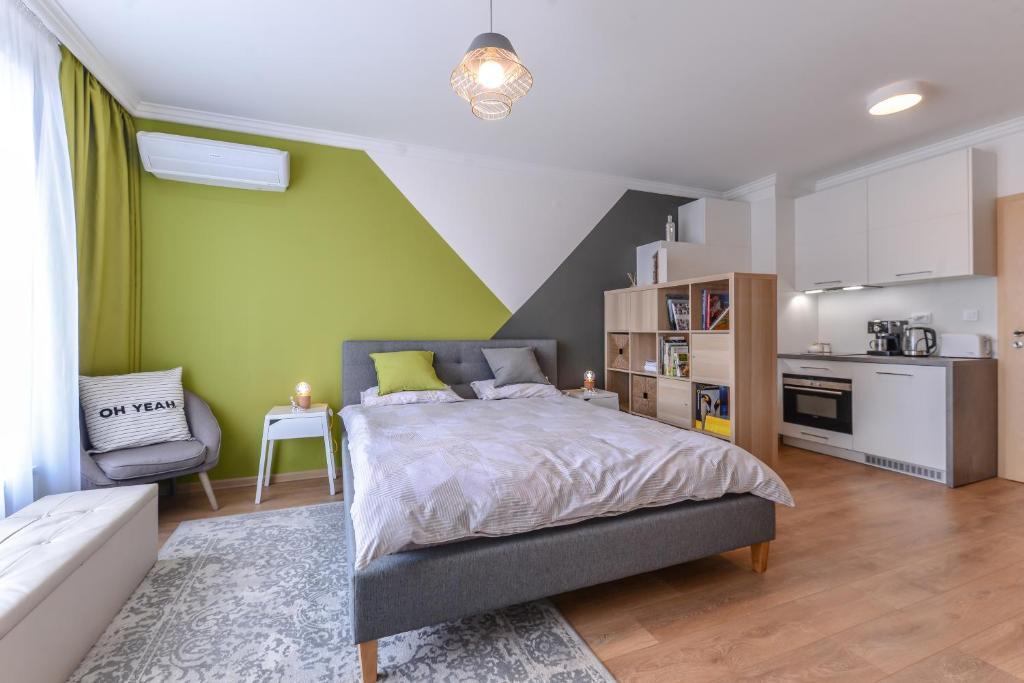 ein Schlafzimmer mit einem großen Bett und eine Küche in der Unterkunft The Spot - fully equipped, central, modern studio by Flat Mаnager in Sofia