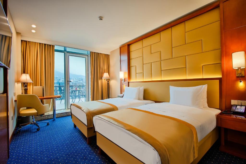 Postel nebo postele na pokoji v ubytování New Tiflis Hotel