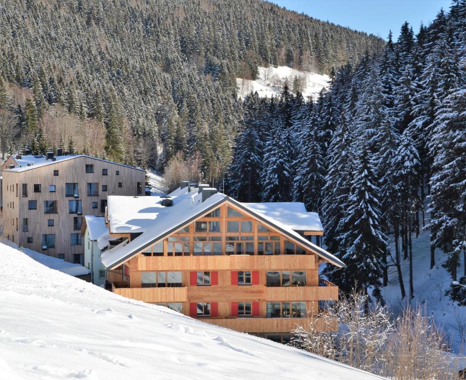 a building on top of a snow covered mountain at Residence Post in Pec pod Sněžkou