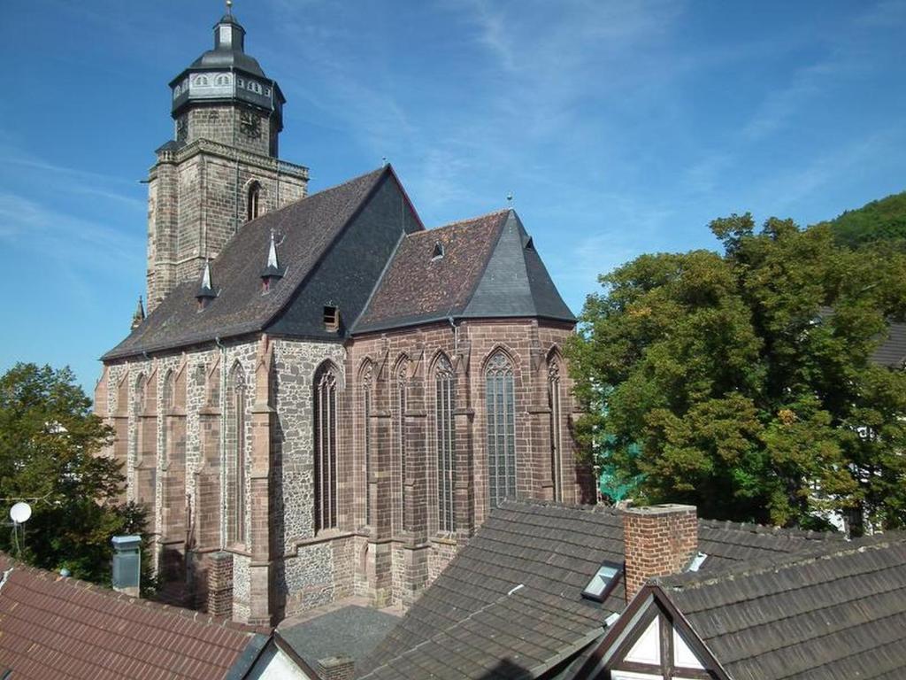 an old church with a clock tower on top of roofs at Ferienwohnungen Homberger Altstadt in Homberg