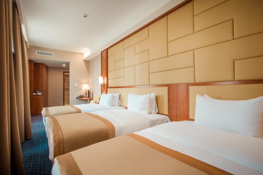 Postel nebo postele na pokoji v ubytování New Tiflis Hotel