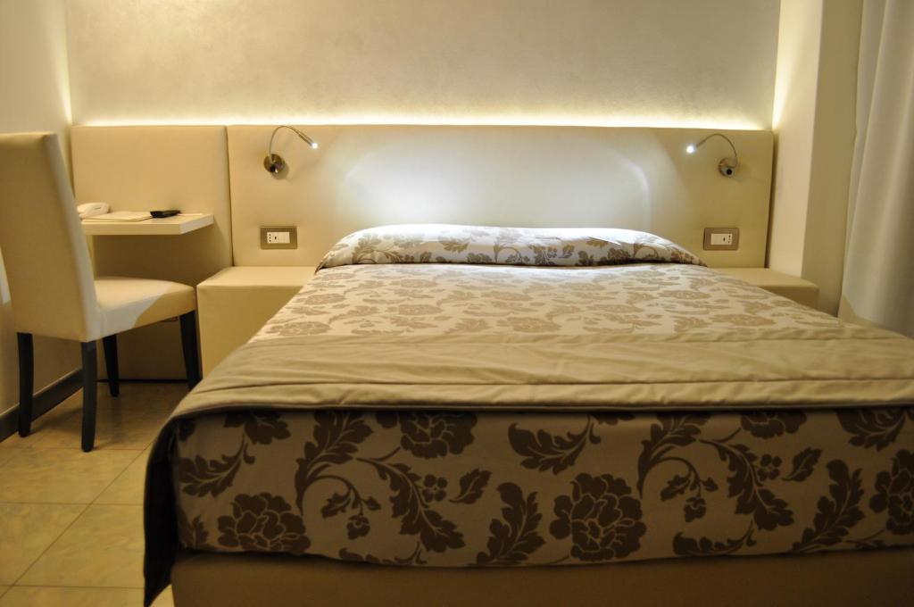 Postel nebo postele na pokoji v ubytování Hotel Garibaldi
