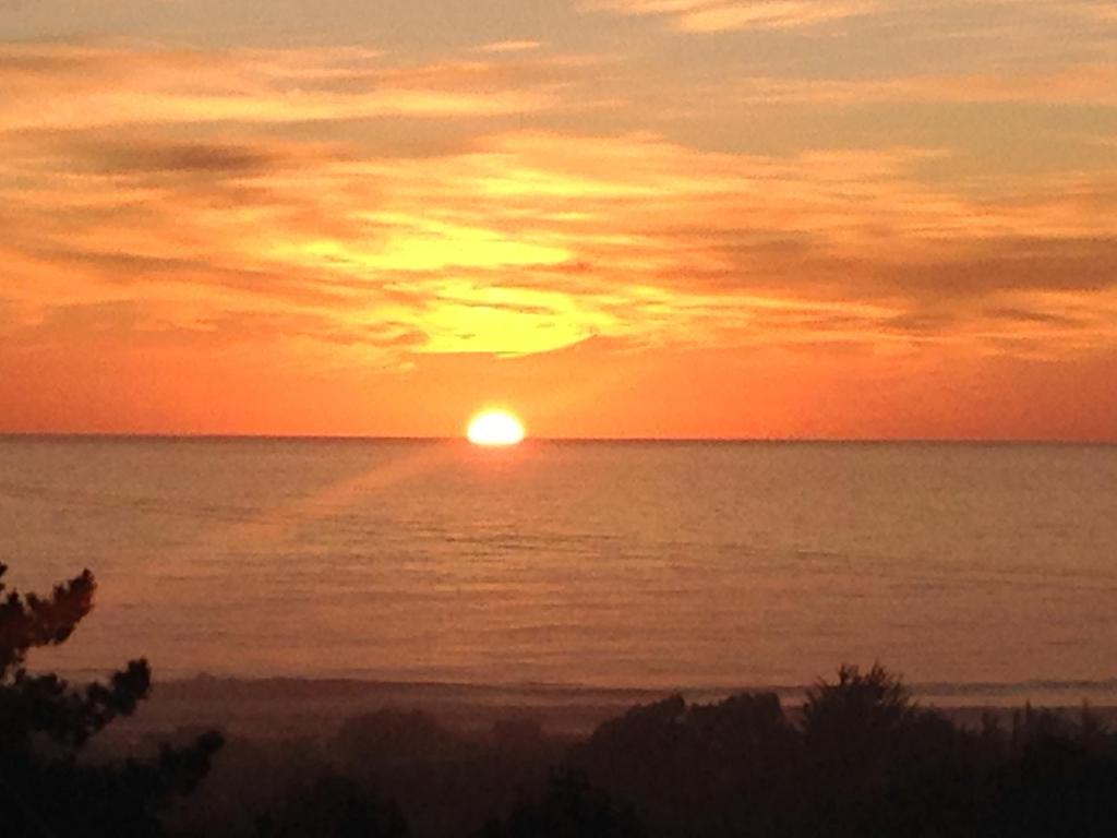a sunset over the ocean with the sun in the sky at VISTA MAR casa familiar para 8 personas in Pichilemu