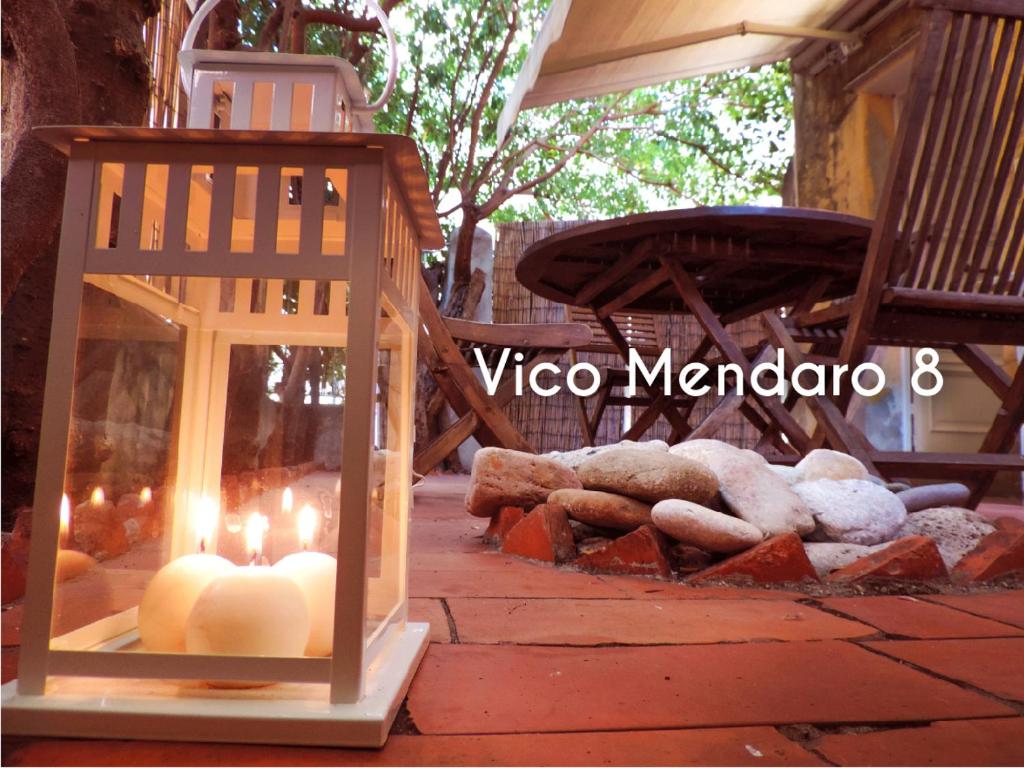 una linterna con velas en un patio con rocas en Le Casasse "Vico Mendaro 8", en Varigotti
