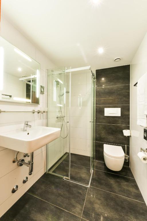 a bathroom with a sink and a shower at City Hotel Heilbronn in Heilbronn