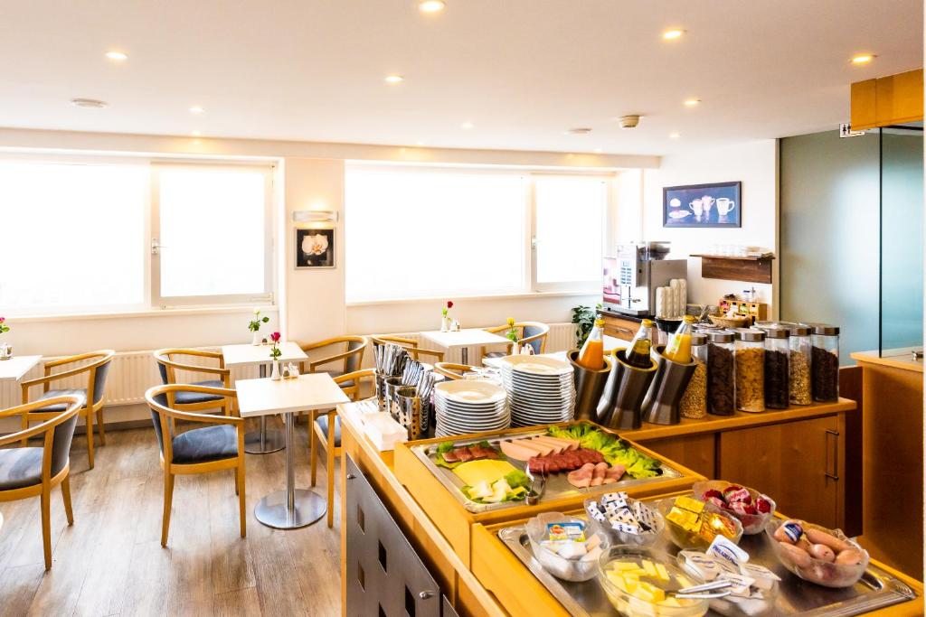 a kitchen with a bunch of food on a counter at City Hotel Heilbronn in Heilbronn