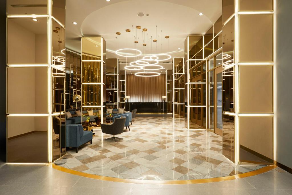 a dressing room with gold walls and a checkerboard floor at The Quarter Ladprao by UHG in Bangkok