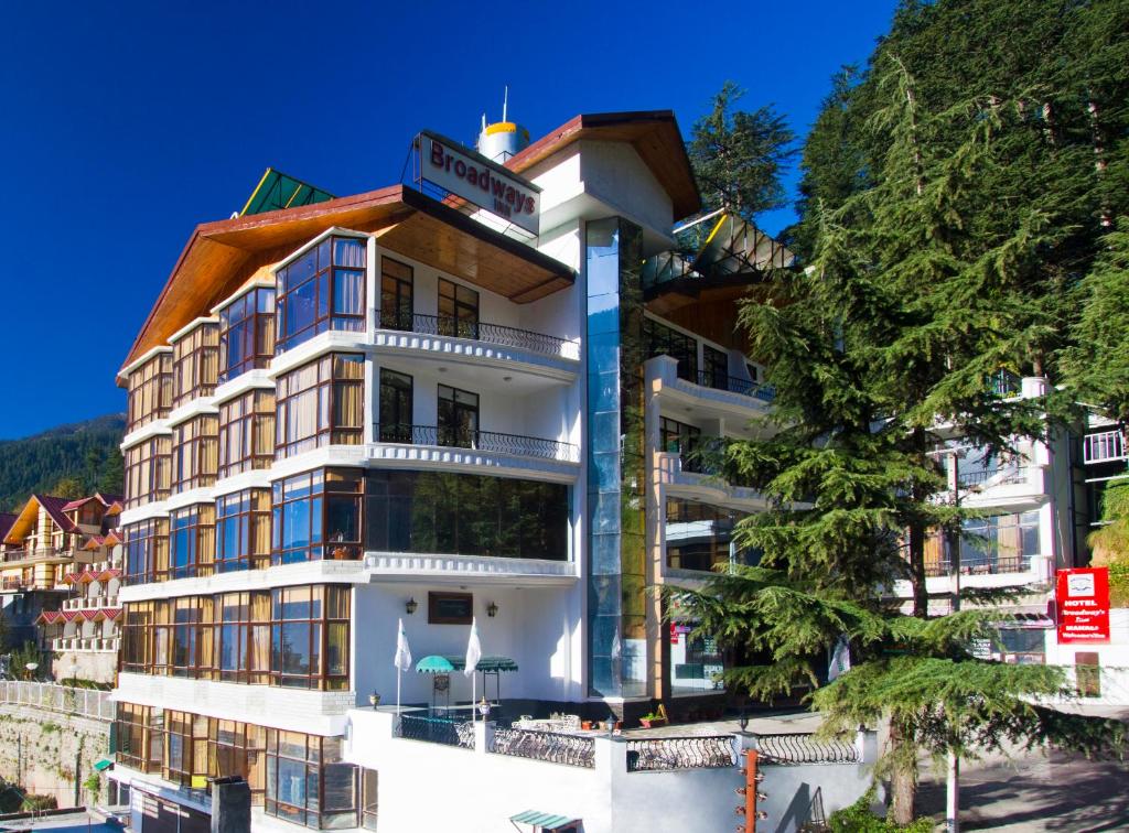 a hotel on the side of a mountain at Hotel Broadways Inn in Manāli