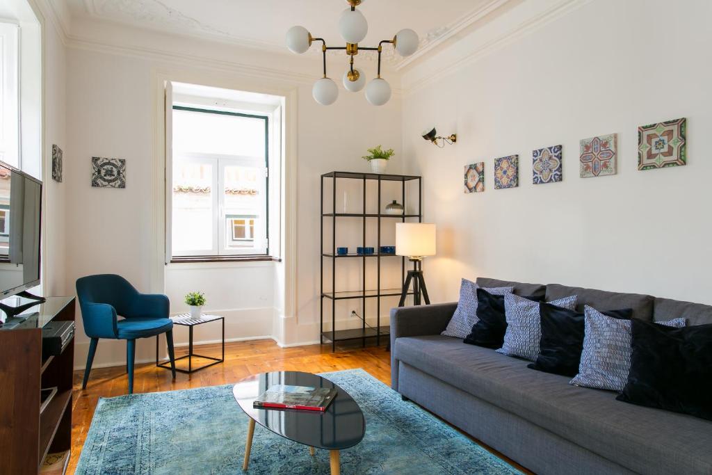a living room with a couch and a table at JOIVY Splendid 2BR flat in Bairro Alto, nearby Luís de Camões Square in Lisbon
