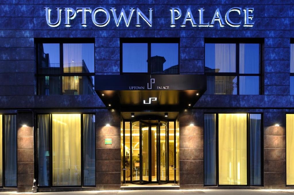 a building with a sign that reads uptown palace at Uptown Palace in Milan