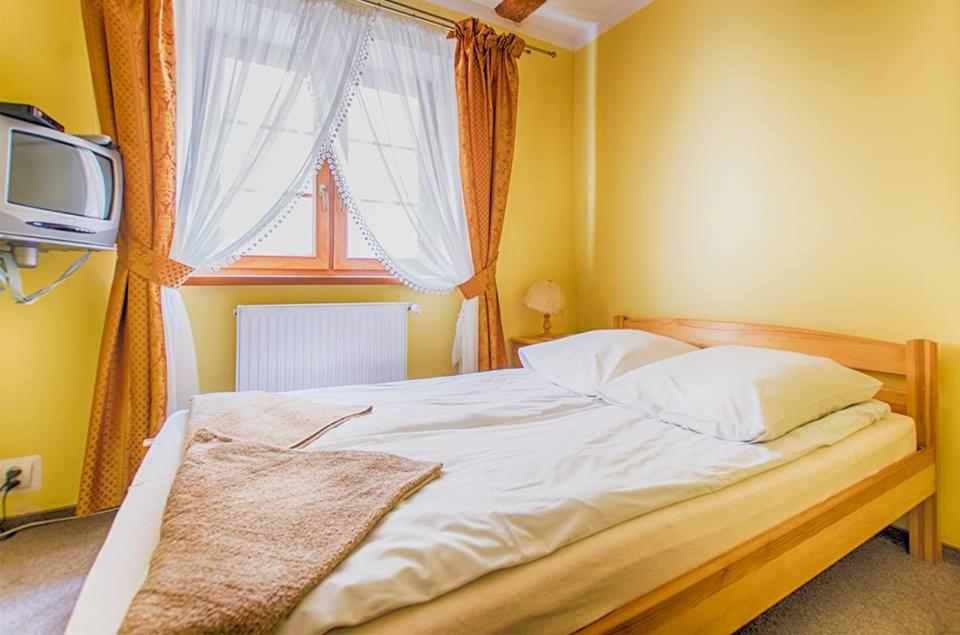 Posteľ alebo postele v izbe v ubytovaní Karczma u Wallenroda