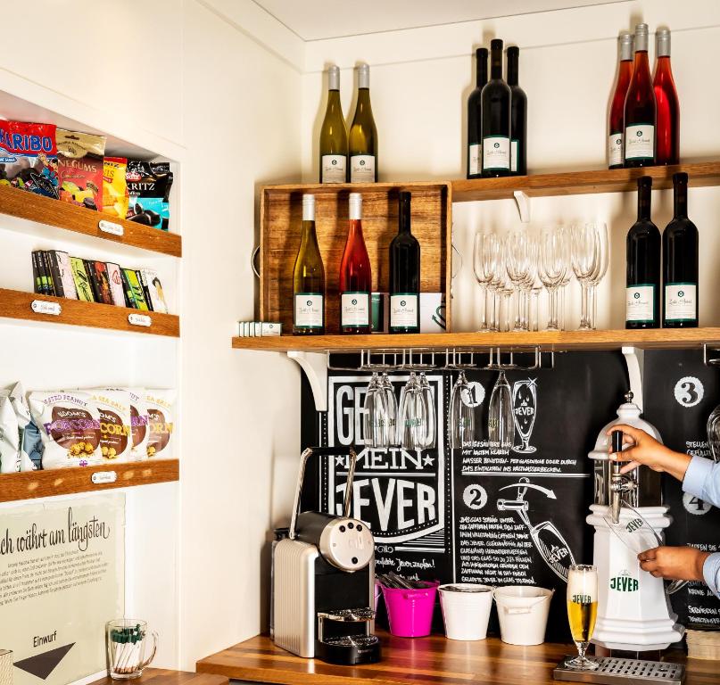 a bar with bottles of wine on the wall at Hotel Zweite Heimat in Sankt Peter-Ording