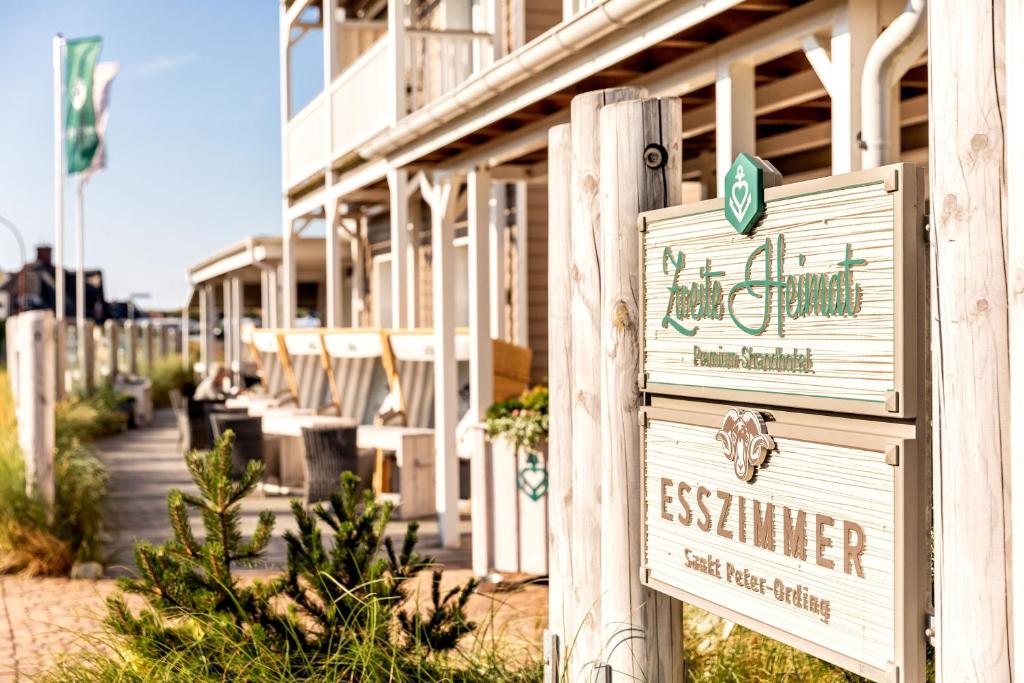 a building with a sign for arequiredrequiredrequiredrequiredrequiredrequiredrequiredrequiredrequired at Hotel Zweite Heimat in Sankt Peter-Ording
