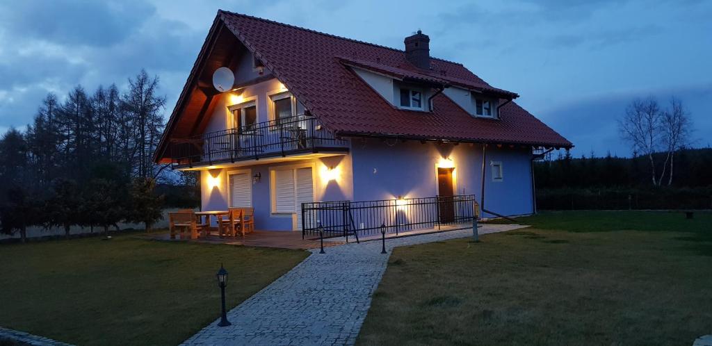 een groot huis met lichten aan de zijkant bij Lawendowy Zakątek in Kołczewo