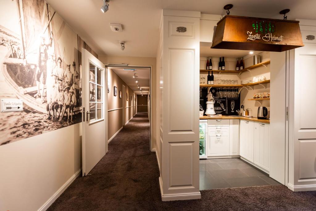 a corridor of a room with a hallway at Hotel Zweite Heimat in Sankt Peter-Ording