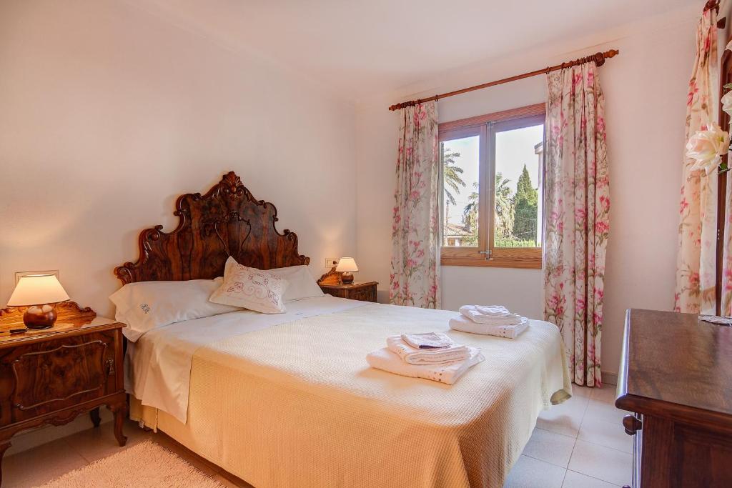 een slaapkamer met een groot bed en een raam bij Codonyer A in Port de Pollença
