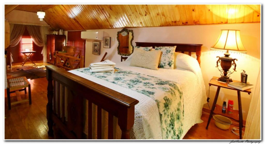 a bedroom with a large bed in a room at Tortelduif Cottage OfftheGrid in Middelburg