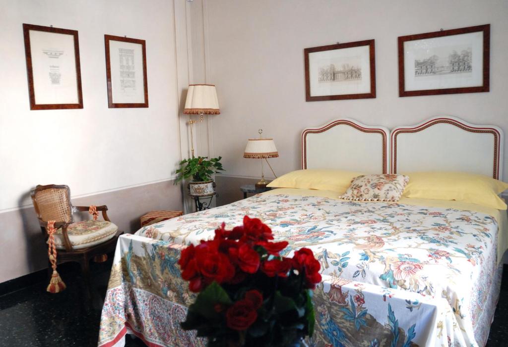 a bedroom with a bed with red roses on it at Bed and Breakfast Flowers in Genova