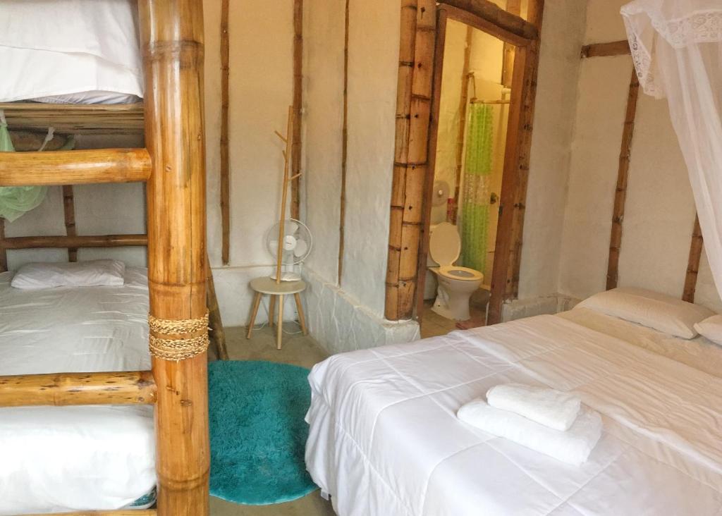 Postel nebo postele na pokoji v ubytování Cabalonga EcoAdventure